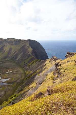 Dramatic Volcano crater near Orongo vilage, Easter Island, grassy walls, sharp rocks, endless oceanの写真素材