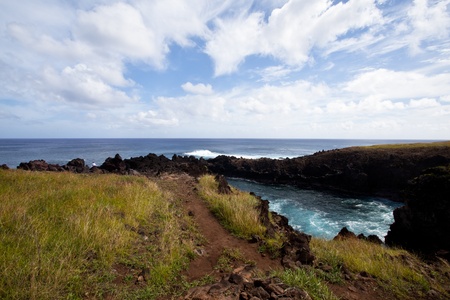 Easter Island rocky coast line under blue skyの写真素材