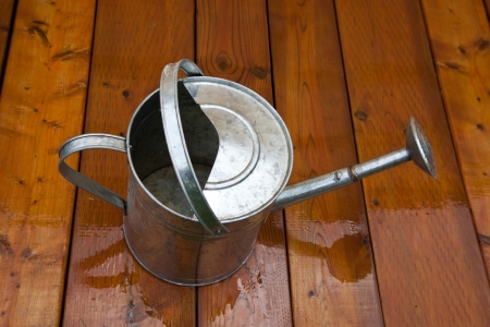 Tin sprinkler on the brown boards, macroの写真素材