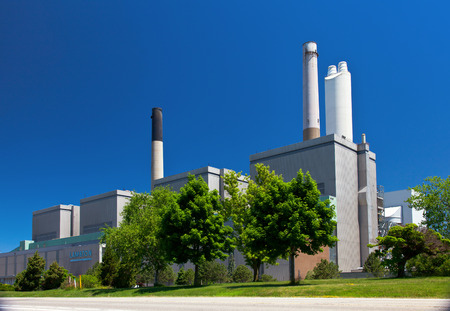 Coal fueled electricity power plant generation station building with smokestack perspective viewのeditorial素材