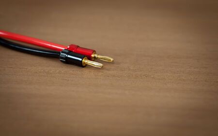 Speaker Inter Connect Audio Wire Cable with Banana Male Plug on Wooden Deskの写真素材