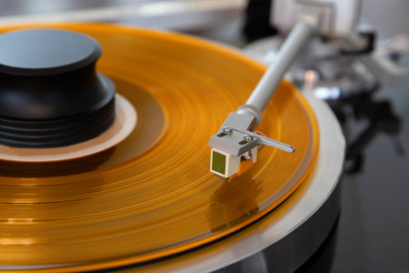 Vintage Stereo Turntable Vinyl Record Tonearm Cartridge Closeup.  Stylus Flies Above Colored Record...