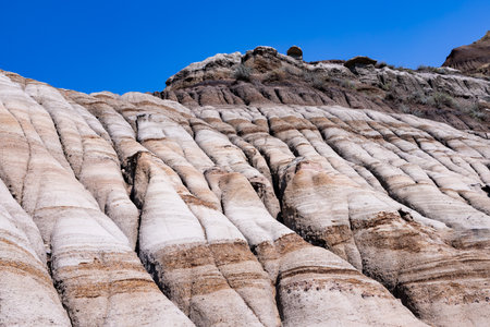 Badlands near Drumheller, Dinosaur capital of the world. One of Canada's most unique landscapes: land of hoodoos, multi-hued canyons and land formations sculptured by water and windの写真素材