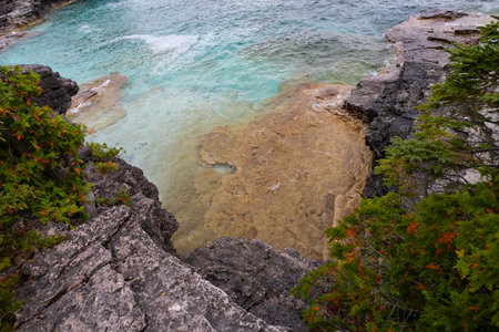 Sandy Limestone Platforms in Turquoise waters of Lake Huron shoreline coast beach, stormy autumn day near Indian Head Trail, Ontario, Canada,の写真素材
