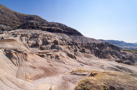 Surreal Badlands Sandstone Formations near Drumheller, Land of hoodoos, multi-hued canyons and geological erosion sculptured by water and wind, Alberta, Canadaの写真素材