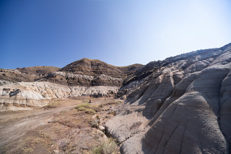 Surreal Badlands Sandstone Formations near Drumheller, Land of hoodoos, multi-hued canyons and geological erosion sculptured by water and wind, Alberta, Canadaの写真素材