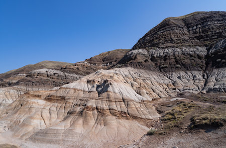 Surreal Badlands Sandstone Formations near Drumheller, Land of hoodoos, multi-hued canyons and geological erosion sculptured by water and wind, Alberta, Canadaの写真素材