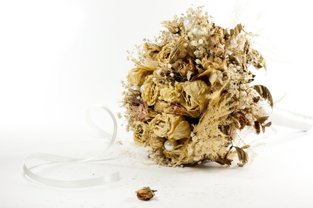 Bouquet of wilted flowers lay isolated on a white backgroundの写真素材