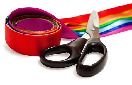 Scissors and a satin ribbons isolated on the white backgroundの写真素材