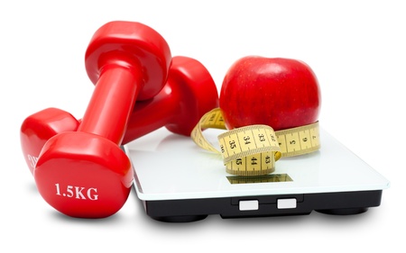 Scales, dumbbells, red apple and measuring tape isolated on the white background. Diet concept.の写真素材