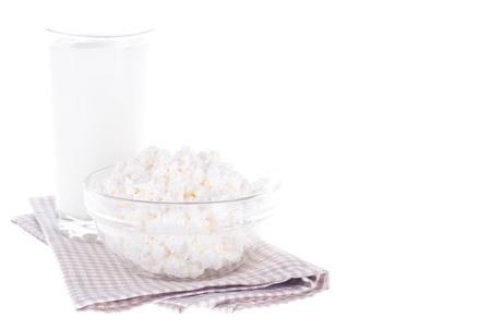Glass with milk and bowl with curd over napkin, isolated on a white   With sample textの写真素材