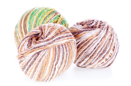 Three balls of colored cotton knitting yarn on the white backgroundの写真素材