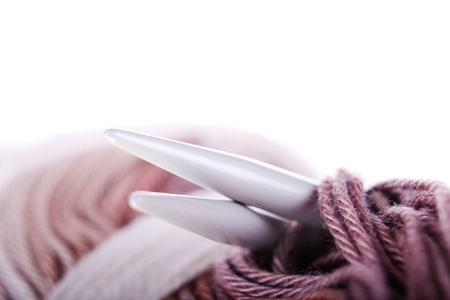 Skeins of yarn, needles closeup on the white background  With sample text 