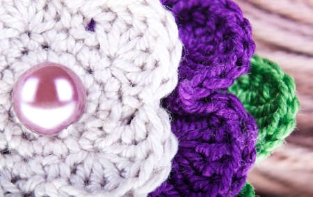 Background of the colored knitted flower close up の写真素材