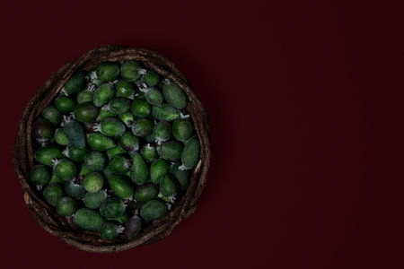 Ripe fresh green Feijoa berries on a dark colored background. contrast of color and shape. Selective focus. Horizontal Top View of Organic Food Healthcare.の写真素材
