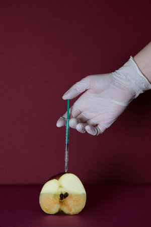 Pandemic concept. A close-up of a fresh red apple as a symbol of a healthy and strong body. Vaccination against the virus. Coronavirus vaccination advertisement.の写真素材