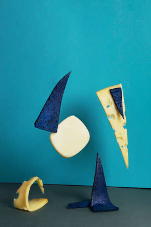 slices of cheese of different varieties flying in the air are captured with high synchronization speed. soft selective focus.food photography in a new style. presentation of a premium class restaurantの写真素材