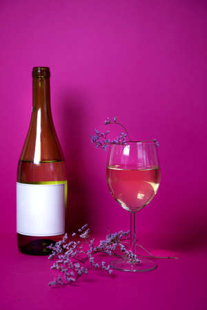 lavender with a glass of fragrant white wine on a bright background. the combination of the tenderness of the flower with the aroma of white wine sorda Shardane. advertising of wines and restaurants.の写真素材