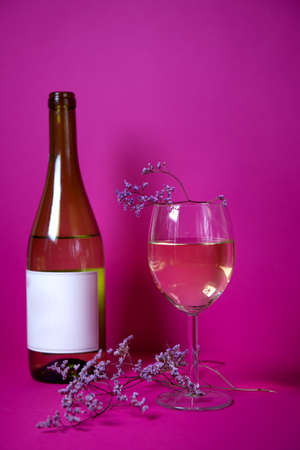lavender with a glass of fragrant white wine on a bright background. the combination of the tenderness of the flower with the aroma of white wine sorda Shardane. advertising of wines and restaurants.の写真素材