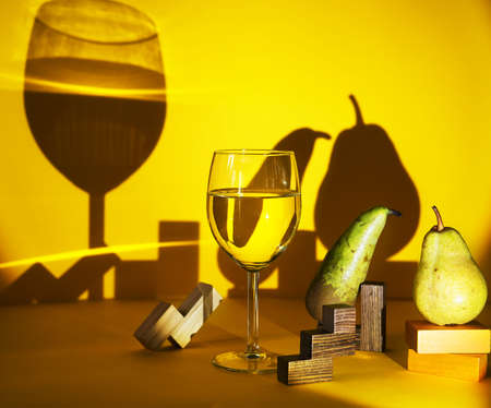 a glass of white wine on a yellow background. exclusive design and development of advertising of...