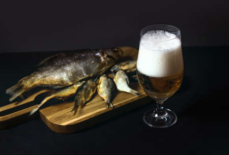 dried salted roach, delicious clip fish on a wooden background. A popular beer snack. Traditional...