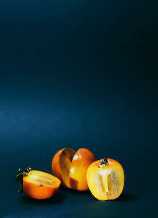 juicy fruits on a dark background in different states, from whole to quarter. advertising a good offer. training and psychological assistance center. copy spaceの写真素材