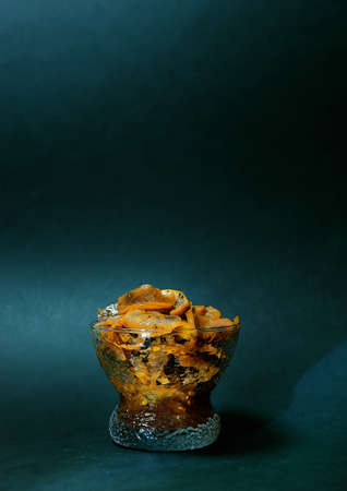 exotic dessert on a dark background in a stylish design. the game of chiaroscuro gives a mysterious charm and mood. advertising of premium class restaurants. and innovative products and services.の写真素材