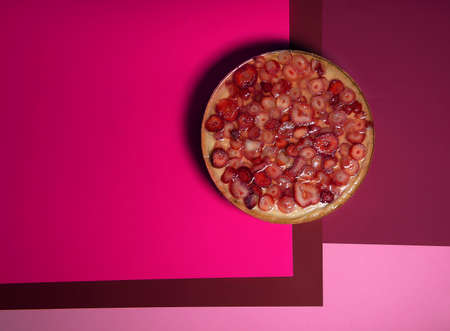 Strawberry cheesecake top view from above. A classic dessert is a delicious homemade cheesecake decorated with slices of fresh strawberries. excellent advertising of goods and services. a sweet offerの写真素材