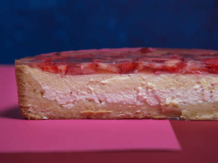 Strawberry cheesecake close - up in the section. food advertising, for menus and banners. A classic dessert is a delicious homemade cheesecake decorated with slices of fresh strawberries. copy spaceの写真素材