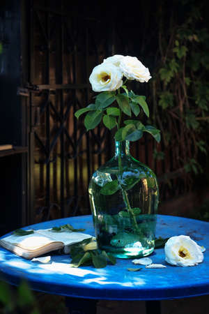 roses in a glass vase in the sunlight near a village house in the summer countryside. an atmospheric rural moment. space for text. I was collecting wildflowers. beautiful sunshineの写真素材