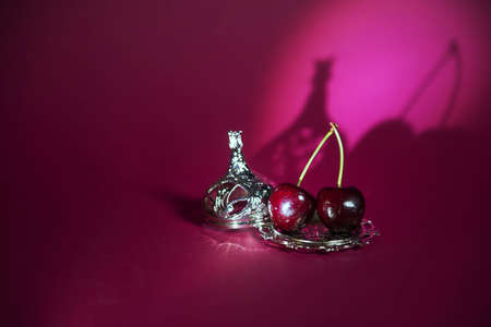cherry on a shiny dish with a vintage-style lid, suitable for advertising confectionery products, as well as for advertising cafeteriasの写真素材