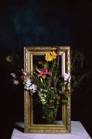 a stylish bouquet of different wild flowers with lilies on a dark background. Still life in the style of old Dutch masters. Large format for printing paintings in the interior.stylish pictureの写真素材