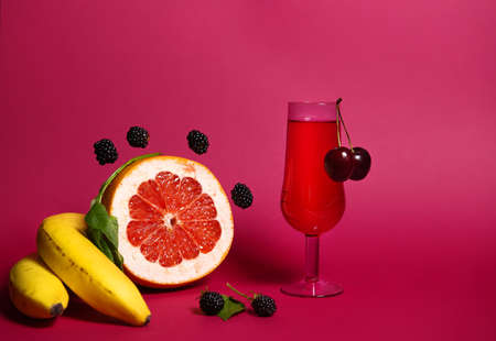 fruit and a glass of red wine on a close-up. with space to copy.stylish photography, the play of chiaroscuro stops the eye and attracts attention. for the presentation of new drinksの写真素材