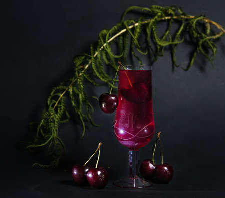 a stylish close-up photo of a glass of red wine. with space to copy. the play of chiaroscuro stops the eye and attracts attention. for the presentation of new drinks.advertising of alcoholic beveragesの写真素材