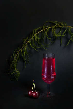 photo of a glass of red wine on a dark background. with space to copy. a stylish composition in...