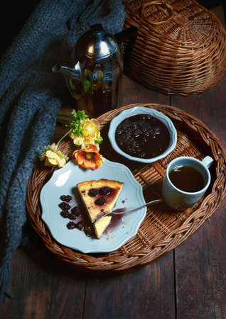 Evening tea with jam and a piece of cake. The cozy atmosphere of the cafe helps to relax and relax in silence.の写真素材
