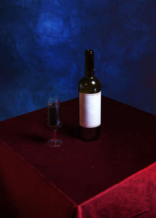 Retro composition with a glass of red wine against a textured blue wall. The concept of a wild vintage Halloween or Thanksgiving party. conceptually, in the style of minimalism.stylish interior designの写真素材