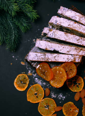 Christmas cake. Traditional homemade Christmas cake on a dark background, place for text. Banner design. selective focus, photography in low key. aromas of the new year.の写真素材