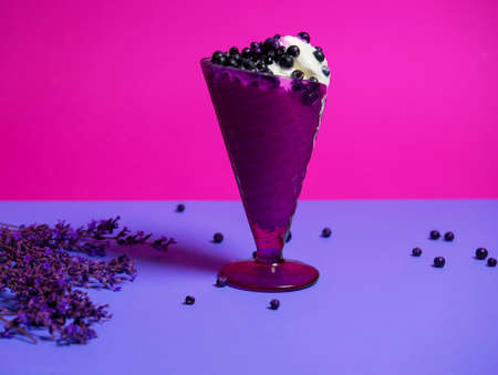 dessert of ice cream in a purple vase with fresh blueberries and lavender sprigs. Dessert for a hot party. isolated object. copy space, advertising - suitable for any field of activity. Vary periの写真素材