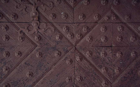 Medieval church door. Detail of the door of the Gothic church. background of old grunge, texture of medieval ornament. part of a vintage old door.の写真素材