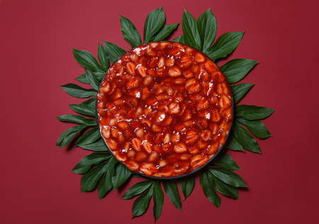 Strawberry pie on a bright background, decorated with fresh mint leaves. isolated, soft focus, bright greeting card, restaurant advertisement, for menu. copyspace. traditional summer cakeの写真素材