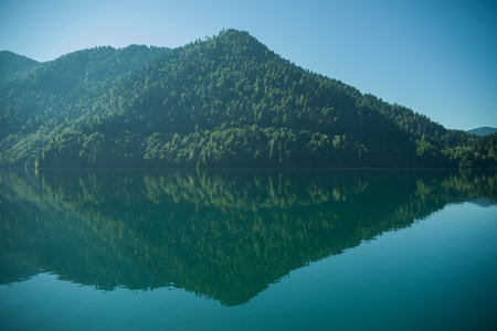 Magnificent view of the summer of the lake in the morning in the rays of the sun. Type of lake in the mountains of the Caucasus. Wildlife during sunrise. Magnificent summer landscape. ideas for designの写真素材