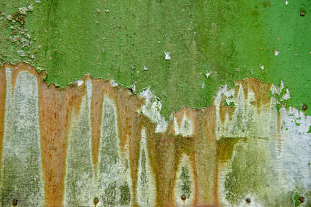 The texture of an old worn-out wall in green tones. Old boards with peeling paint, covered with lichen. desolation. Rough, battered surface in green shades. space for copying. artistic backgroundの写真素材