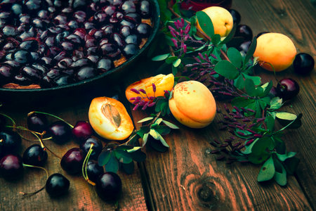 A delicious and juicy composition of apricots and cherries for the table. cherry pie for tea. Bright advertising for a pastry shop.の写真素材