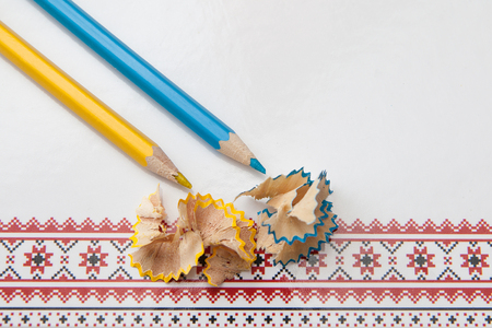 yellow and white pencil shavings on white paper background with a patternの写真素材