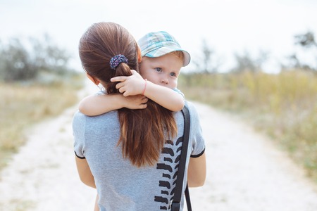 Happy boy in mother's hands, hugs, smiles, laughs, love happinessの写真素材