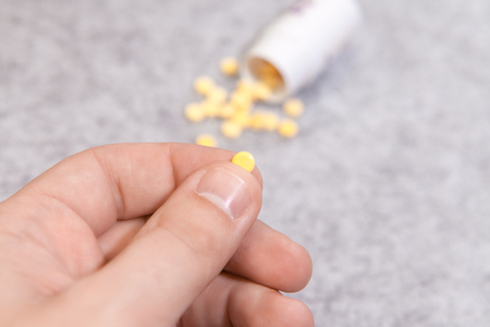 Taking medicine pills in hand, analgesic, treatの写真素材