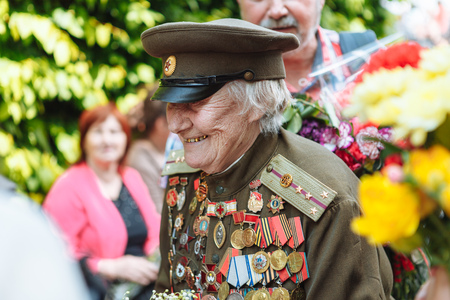 UKRAINE, KIEV, MAY 9, 2016, Victory Day, May 9. Monument to an unknown soldier: Veterans of World War II carry flowers to the monument of an unknown soldierのeditorial素材