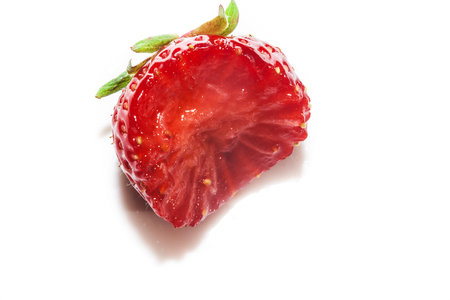 Strawberry with a bite. Isolated over white background, Bitten strawberry isolated on white background.の写真素材