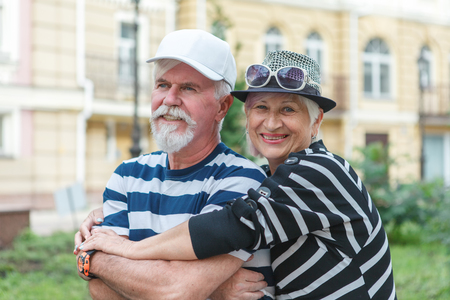 Loving elderly couple posing on camera. Pensioners hug each other. Happy old people.の写真素材